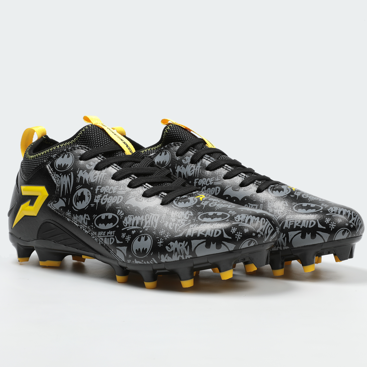 Black and gray soccer cleat with yellow accents on a light gray background